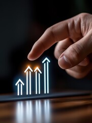 Hand pointing at a graphical representation of growth and success, symbolizing business progress and strategies.