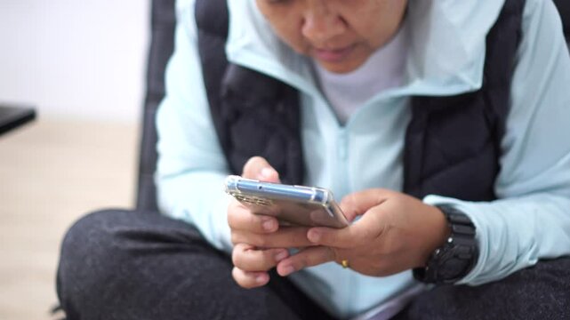 ASEAN tourists Using smartphone check flight schedule information while waiting to check in at airport terminal for travel relax on holiday and Touching gadget choose app