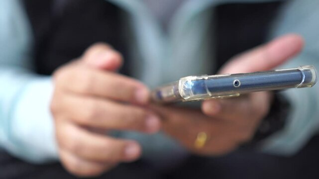 ASEAN tourists Using smartphone check flight schedule information while waiting to check in at airport terminal for travel relax on holiday and Touching gadget choose app