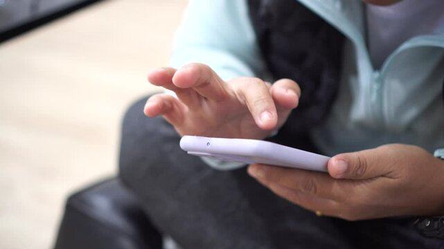 businessman using mobile phone,Touching gadget choose app. ASEAN tourists Using smartphone check flight schedule information while waiting to check in at airport terminal for travel relax