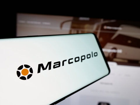 Stuttgart, Germany - 12-19-2024: Smartphone with logo of Brazilian automotive company Marcopolo SA on screen in front of business website. Focus on left of phone display.