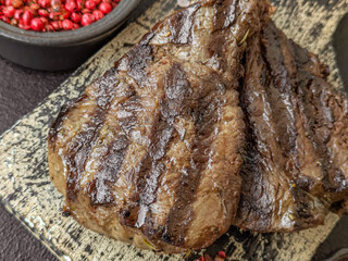 Grilled beef steak with salt, spices and herbs
