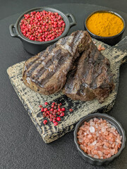 Grilled beef steak with salt, spices and herbs