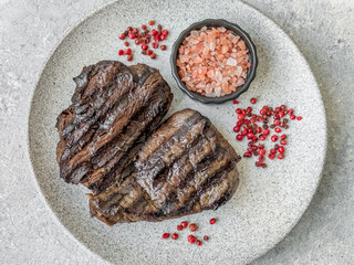 Grilled beef steak with salt, spices and herbs