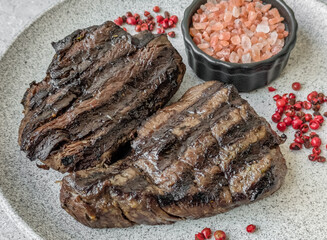 Grilled beef steak with salt, spices and herbs