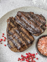 Grilled beef steak with salt, spices and herbs