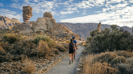 Hikers, equipped with backpacks, add a sense of scale and adventure. walking along a scenic trail...
