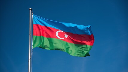 The Azerbaijani flag flying high under a clear blue sky