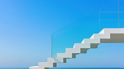 Obraz premium Modern white stairs with glass railing against a clear blue sky and ocean.