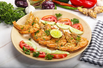 Grilled prawn served lime and vegetables