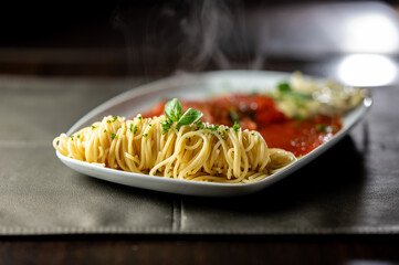 Spaghetti pasta with tomato sauce, basil, herbs ,parmesan cheese