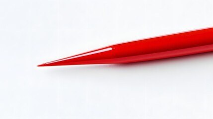 A Vibrant Red Pointed Object Against White Background