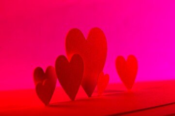 Red and Pink colors with paper hearts in the foreground
