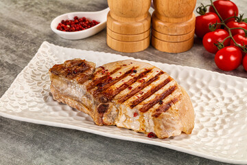 Grilled pork loin steak with bone