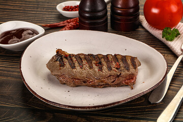 Grilled beef striploin steak with sauce