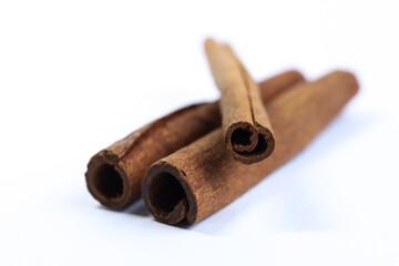 Cinnamon sticks isolated on white background. Selective focus and shallow depth of field.