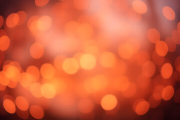 Obraz premium A blurred image featuring a series of warm orange bokeh lights, creating a dreamy and festive atmosphere. The lights are scattered and form abstract patterns against a soft background.