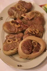 Close-up of cooked pork shank on a plate on the table