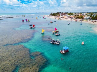 Porto de Galinhas - aerial view of the natural pools of Porto de Galinhas at low tide full of rafts