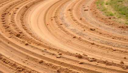 Naklejka premium graded clay-rich dirt along a turn at a dirt race track, smooth light. isolated with white highlights