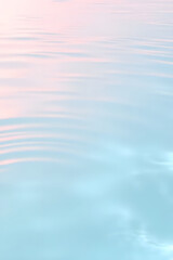 Naklejka premium Close-up of gentle ripples on a calm water surface, creating a soothing and serene pattern. Wellness, cosmetics, and eco-friendly advertising banners.