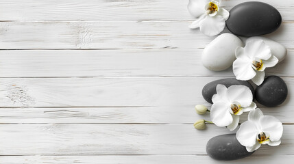 massage stones with white orchids on white wooden background.
