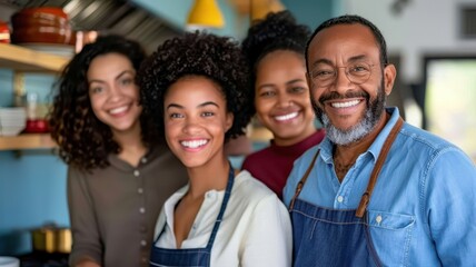 Fototapeta premium A joyful group of four people, smiling and dressed in aprons, standing together in a cozy cafe setting.