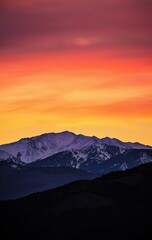Vibrant Sunset Over Snow-Capped Mountain Range