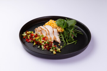 Fried egg with mash and grilled vegetables in a plate on a light background.