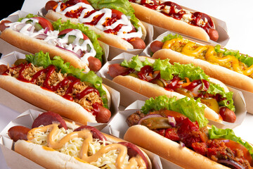 Assorted different hot dogs on a light background.