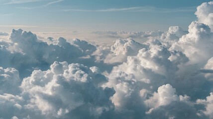 A large, billowing cumulus cloud formation against a clear blue sky, seen from above, possibly from an airplane.
