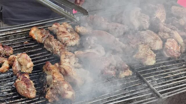 Close up shot of sizzling pork chop on a outdoor grill