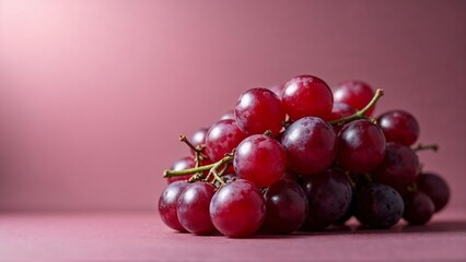 Bunch of purple grapes on pink background