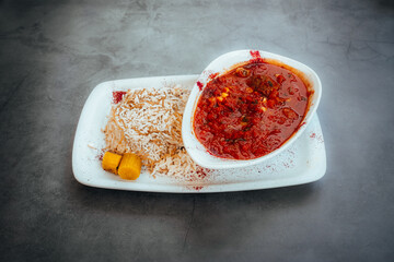 Hearty Beef Stew with Rice and Pickled Vegetables on a Modern Plate