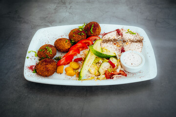 Falafel Plate with Hummus, Fresh Vegetables, and Dipping Sauce