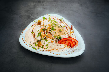 Garnished Hummus Plate with Vegetables and Herbs