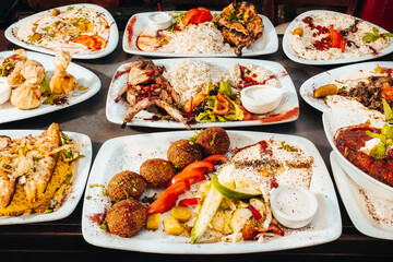 Vibrant Mediterranean Feast with Grilled Meats, Falafel, and Hummus Platters