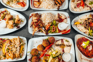 Assorted Mediterranean Dishes with Grilled Meats, Rice, and Dips Top View