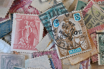 Closeup on a scattered collection of a variety of international used Vintage Postage Stamps