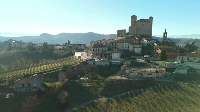 Panorama by drone of the village of Serralunga, surrounded by hills covered of vineyards (Piedmont Region, Northern Italy). World famous for its red wine named Barolo, is Unesco site.