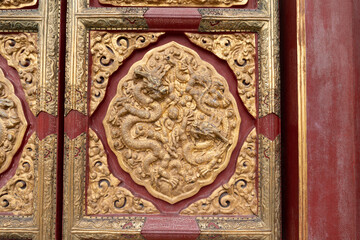 A dragon motif on the wooden door of the Forbidden City in Beijing