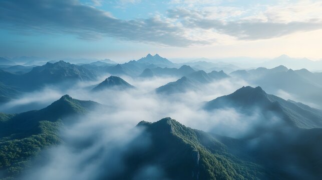 Aerial view of misty mountains with rolling fog, morning sunlight, and blue sky, creating an ethereal, dreamy landscape with cinematic lighting.