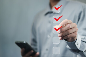 Business performance checklist concept Young business woman using laptop surveys online checklist...