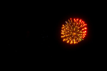 vibrant pink firework bursts dominate the night sky, accented by golden trails and intricate patterns. A spectacular display full of energy and festivity.