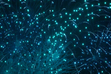 A dazzling display of golden fireworks streaking across the night sky, accented by vibrant red...