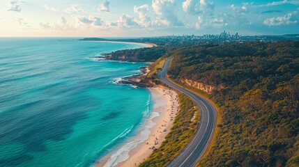 Fototapeta premium Aerial View of Coastal Road and Beautiful Beach with City Skyline