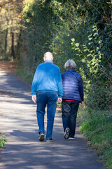 Fototapeta premium A man and woman are walking together on a path