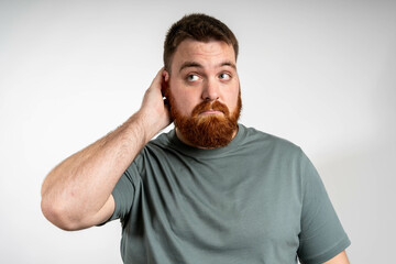 Young man with doubt expression, confused and wonder concept, uncertain future isolated over grey...