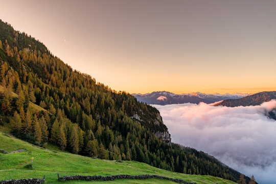 Morning Light in the Rofan Alps with Misty Clouds, Forested Slopes, and Peaceful Mountain Scenery
