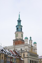 A winter scene of Poznań's old market square captured in January. Snow-covered roofs, the iconic town hall, and clear skies.